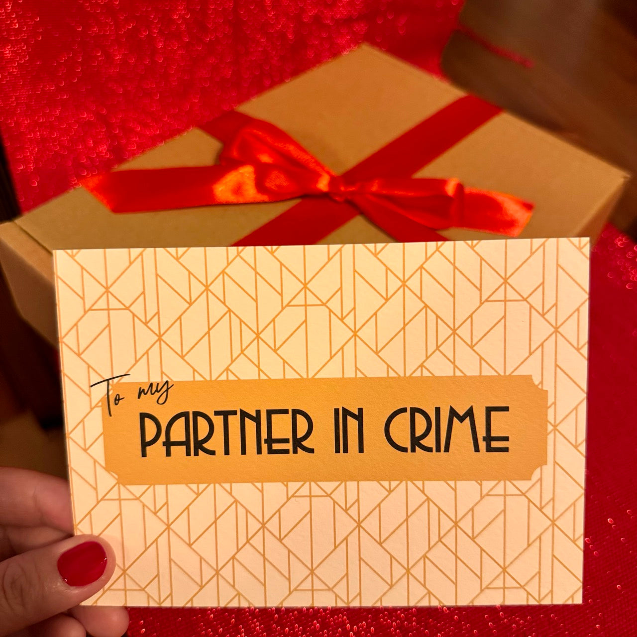 Postcard 'To my Partner in Crime' in front of Gift Box