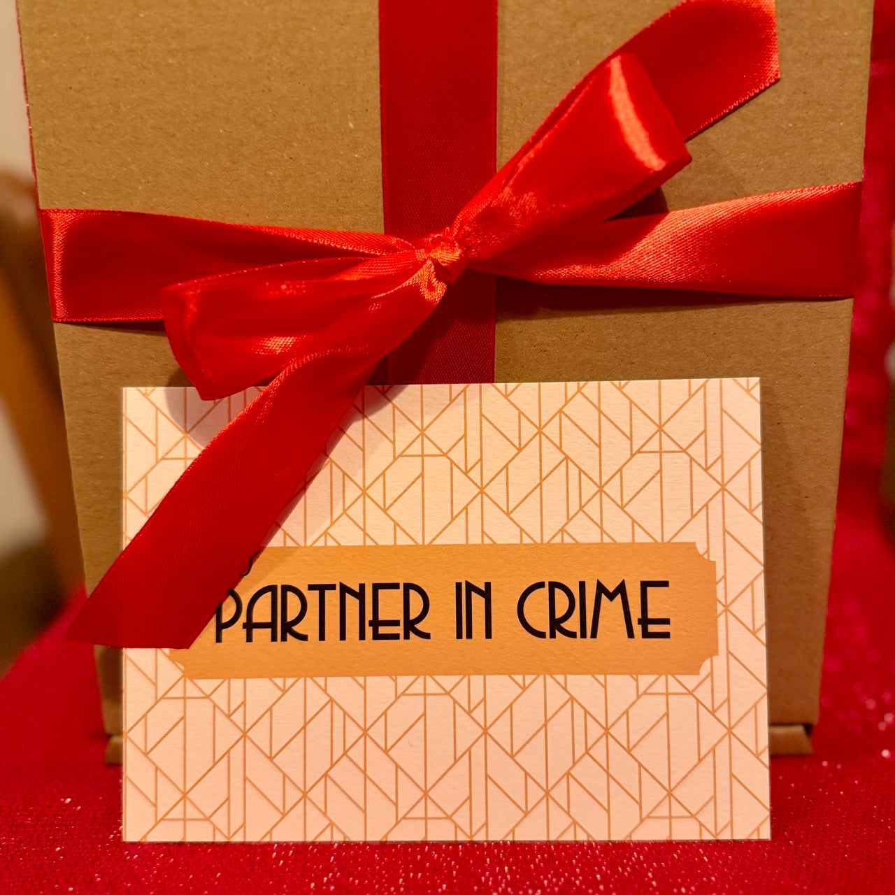 Partner in Crime postcard in front of Gift Box