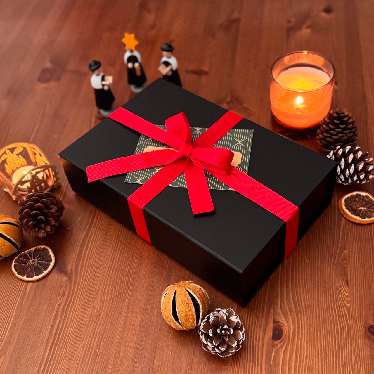 Cozy murder mystery gift box. Shown among decorative items.