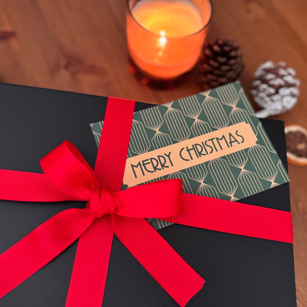 Close up of cozy murder mystery gift box. Shown among decorative items.