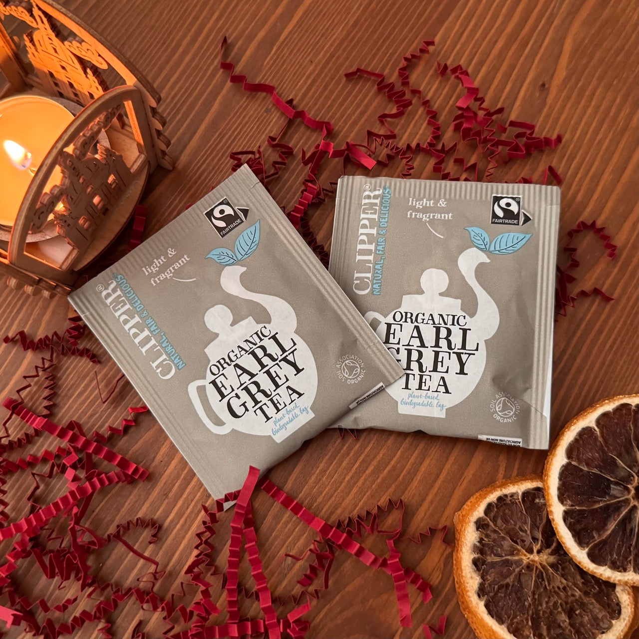 Tea bags for Earl Grey tea, part of the cozy murder mystery gift box. Shown among decorative items.