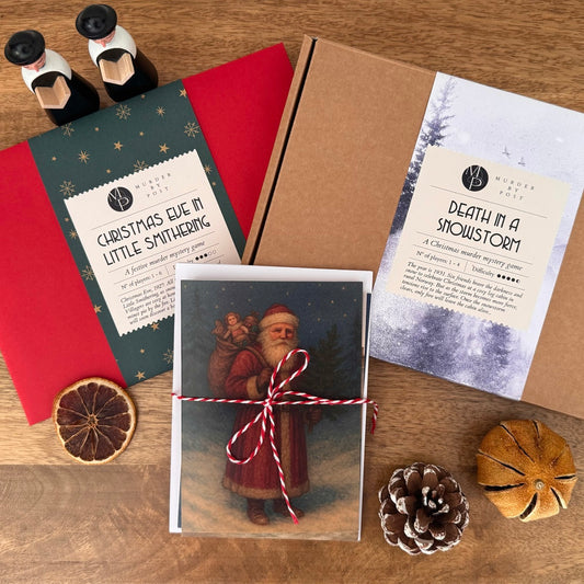 Collection of Christmas-themed murder mystery games, Christmas cards, and decorative items on a wooden surface.