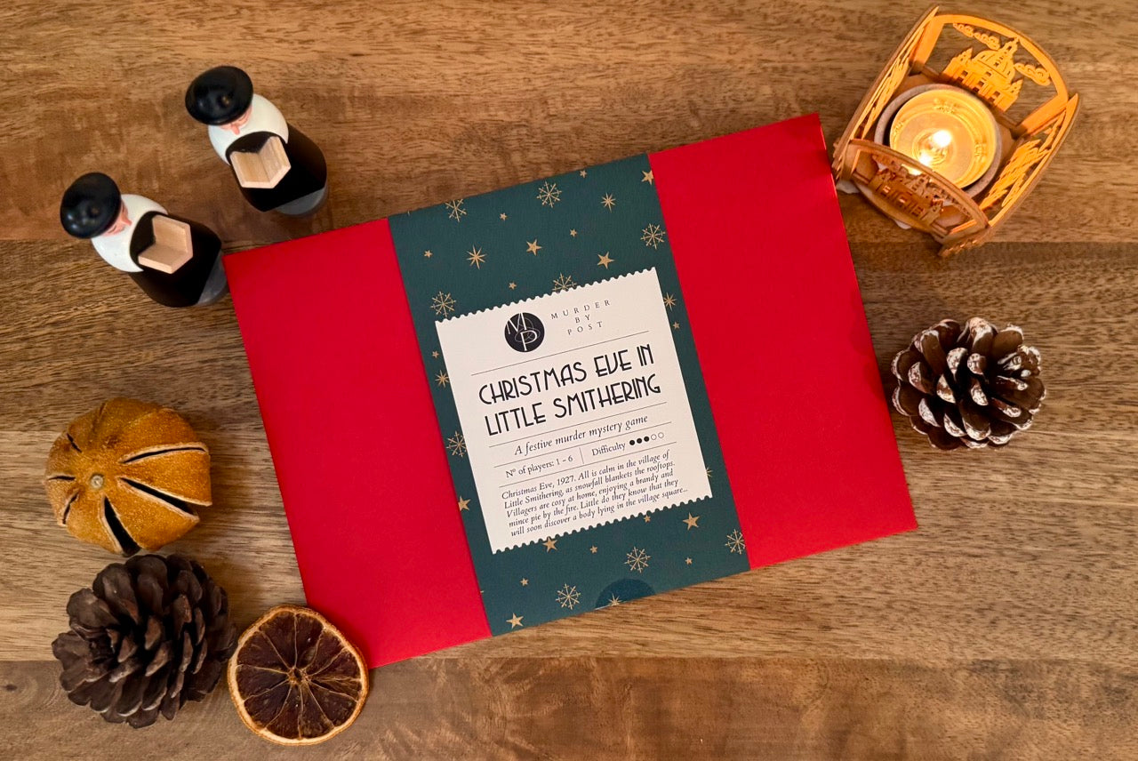 Murder mystery game titled 'Christmas Eve in Little Smithering' on a wooden surface with decorative items.